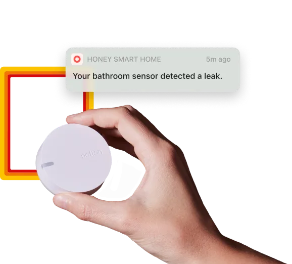 Hand holding a home sensor.