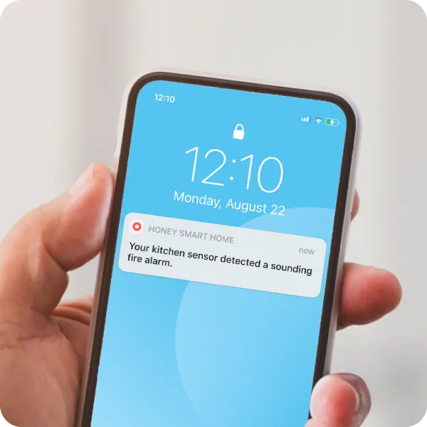 A phone with an alert from a smart senor.